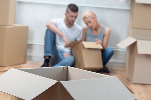 Removal crew preparing boxes and furniture for urgent transport in Belgravia