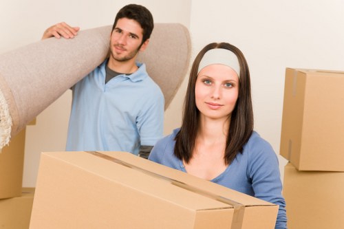 Professional man and van loading boxes for a central London move