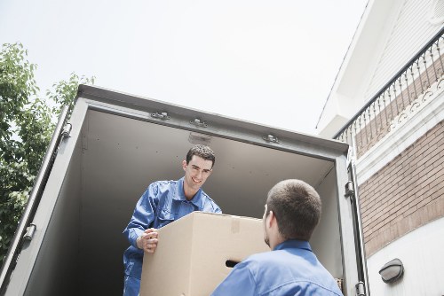 Professional movers handling office equipment in a Belgravia building