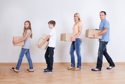 Movers handling furniture and boxes in a central London student relocation