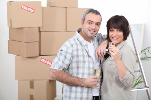 Moving crew handling furniture protection during a Belgravia house move